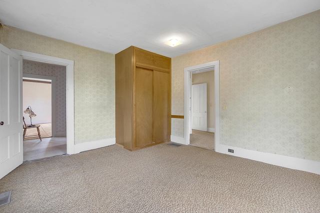 640 Lower St, Turner, ME 04282 - unfurnished bedroom featuring light carpet, wallpapered walls, and a closet