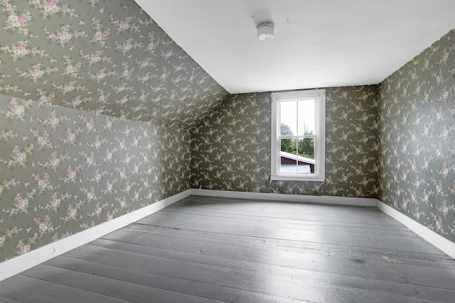 640 Lower St, Turner, ME 04282 - additional living space featuring wallpapered walls, wood-type flooring, baseboards, and vaulted ceiling