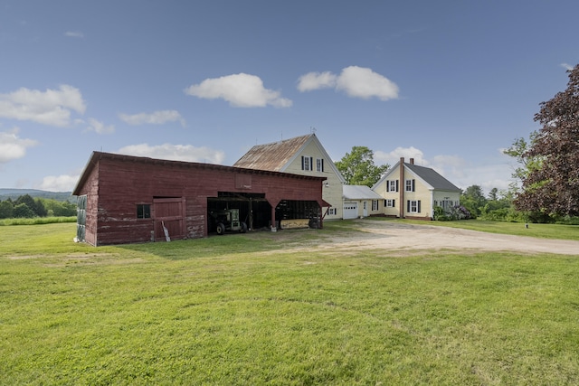 640 Lower St, Turner, ME 04282 - view of home's exterior featuring a yard, an outdoor structure, dirt driveway, and a barn