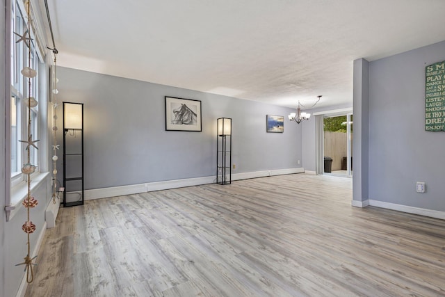 5 Jamestown Ct Unit 5, South Portland, ME 04106 - unfurnished room with a chandelier, wood finished floors, and baseboards