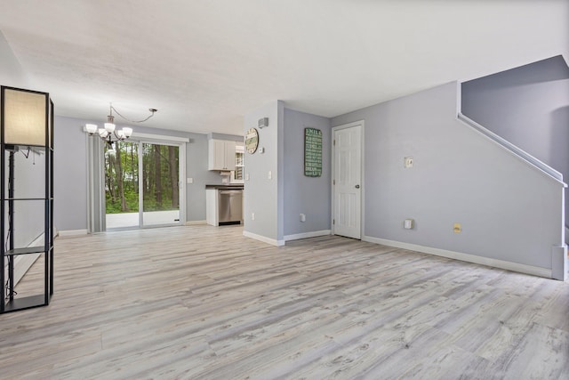 5 Jamestown Ct Unit 5, South Portland, ME 04106 - unfurnished living room featuring a chandelier, light wood-style floors, and baseboards