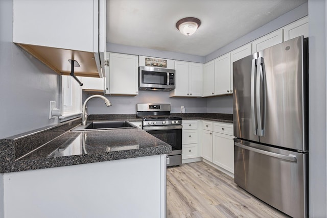 5 Jamestown Ct Unit 5, South Portland, ME 04106 - kitchen with stainless steel appliances, a sink, white cabinets, and light wood-style floors