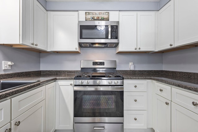5 Jamestown Ct Unit 5, South Portland, ME 04106 - kitchen with appliances with stainless steel finishes, white cabinetry, and dark countertops