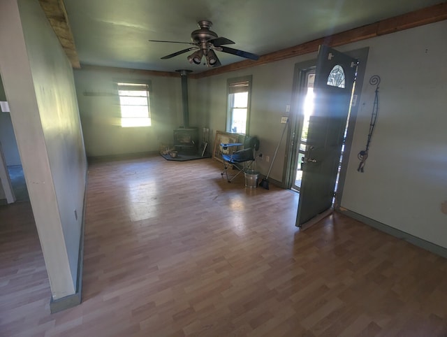 458 Carding Machine Rd, Bowdoinham, ME 04008 - foyer entrance with a wood stove, ceiling fan, wood finished floors, and baseboards