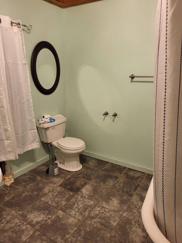 458 Carding Machine Rd, Bowdoinham, ME 04008 - full bathroom featuring baseboards, toilet, a shower with shower curtain, and stone finish floors