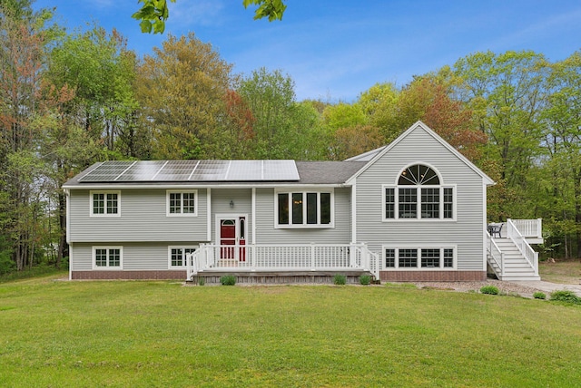 1 Whispering Pines Dr, Old Orchard Beach, ME 04064 - bi-level home with a front yard, solar panels, a wooden deck, and stairway