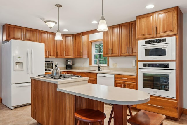 1 Whispering Pines Dr, Old Orchard Beach, ME 04064 - kitchen with white appliances, light countertops, brown cabinets, a sink, and recessed lighting