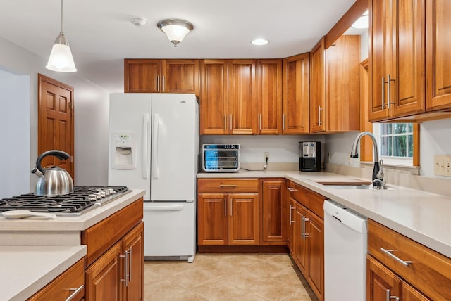 1 Whispering Pines Dr, Old Orchard Beach, ME 04064 - kitchen with white appliances, a sink, brown cabinets, light countertops, and recessed lighting