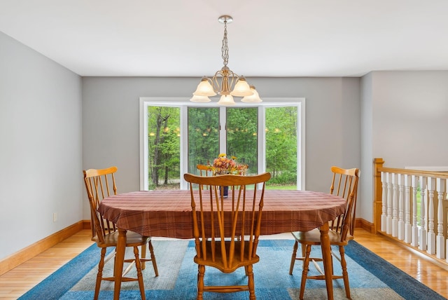 1 Whispering Pines Dr, Old Orchard Beach, ME 04064 - dining room with a chandelier, wood finished floors, and baseboards