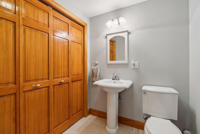 1 Whispering Pines Dr, Old Orchard Beach, ME 04064 - half bath featuring toilet, baseboards, tile patterned flooring, and a sink