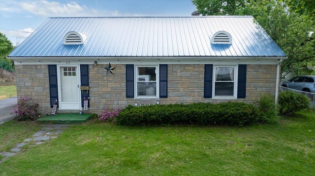 25 Biron Ave, Lewiston, ME 04240 - view of front of property featuring stone siding, metal roof, and a front lawn