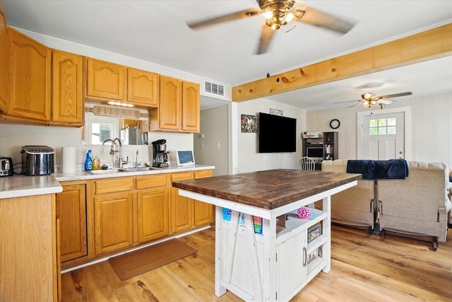 25 Biron Ave, Lewiston, ME 04240 - kitchen featuring a ceiling fan, light wood-style floors, a sink, open floor plan, and wood counters