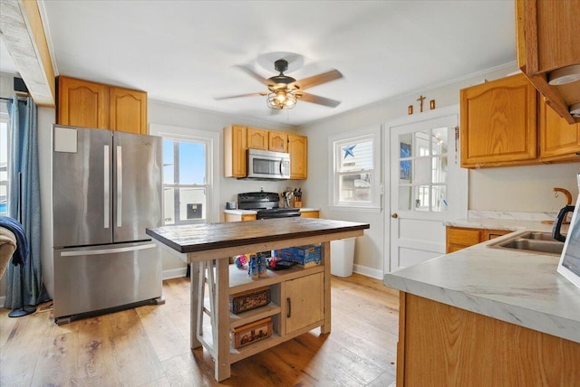 25 Biron Ave, Lewiston, ME 04240 - kitchen with stainless steel appliances, ceiling fan, light wood finished floors, and a sink