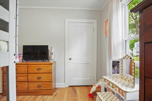 25 Biron Ave, Lewiston, ME 04240 - bedroom with crown molding, light wood-style floors, multiple windows, and baseboards
