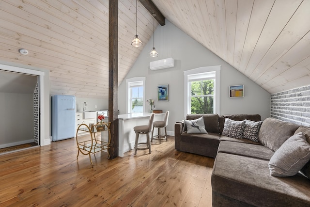 16 Cross St, Camden, ME 04843 - living area with an AC wall unit, wooden ceiling, hardwood / wood-style floors, and baseboards