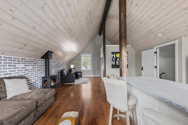 16 Cross St, Camden, ME 04843 - living room with a wood stove, hardwood / wood-style floors, wooden ceiling, brick wall, and baseboards