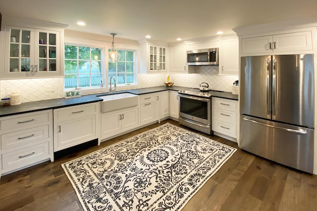 16 Cross St, Camden, ME 04843 - kitchen with appliances with stainless steel finishes, a sink, dark countertops, tasteful backsplash, and recessed lighting
