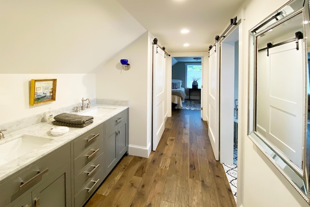 16 Cross St, Camden, ME 04843 - ensuite bathroom with wood-type flooring, double vanity, lofted ceiling, and recessed lighting