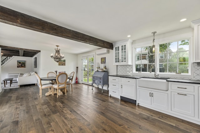16 Cross St, Camden, ME 04843 - kitchen with a sink, dark countertops, white cabinets, dark wood-style flooring, and tasteful backsplash