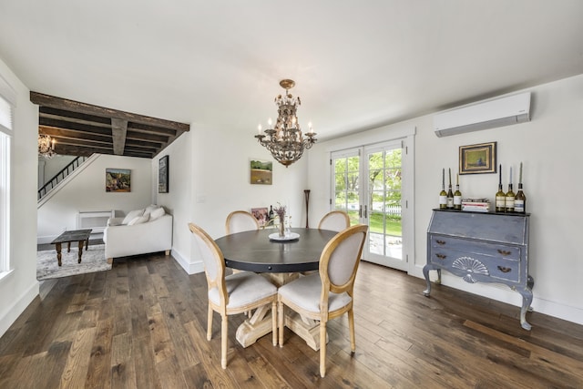 16 Cross St, Camden, ME 04843 - dining room with a wall mounted AC, a chandelier, dark wood-style floors, stairway, and baseboards