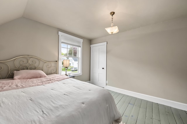 16 Cross St, Camden, ME 04843 - bedroom with baseboards, wood finished floors, and vaulted ceiling