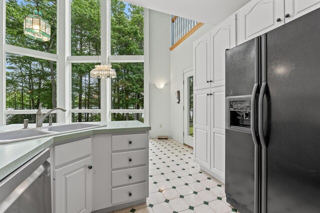 73 Hodsdon Ln, Jefferson, ME 04348 - kitchen featuring black fridge, dishwasher, light flooring, plenty of natural light, and a high ceiling