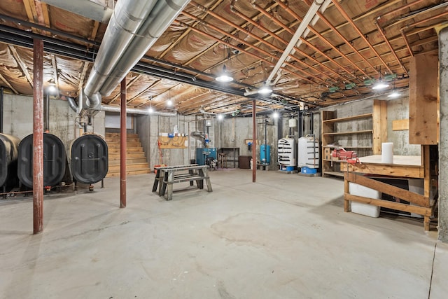 73 Hodsdon Ln, Jefferson, ME 04348 - unfinished basement featuring oil tank, a water pressure tank, stairway, and a heating unit