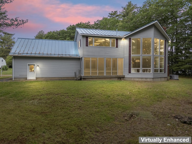 73 Hodsdon Ln, Jefferson, ME 04348 - back of property featuring a standing seam roof, a metal roof, a lawn, and a sunroom