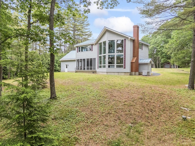 73 Hodsdon Ln, Jefferson, ME 04348 - rear view of property with a chimney, a metal roof, and a lawn