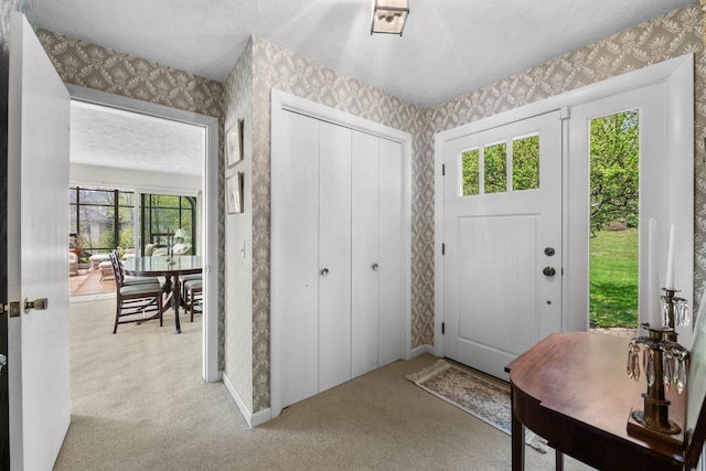 21 Ledge Rd, Cumberland, ME 04110 - foyer featuring wallpapered walls, light colored carpet, and plenty of natural light