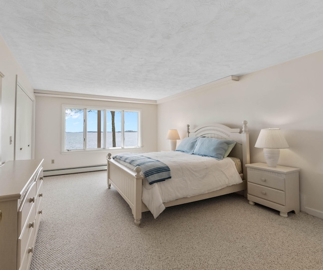 21 Ledge Rd, Cumberland, ME 04110 - bedroom featuring baseboard heating, light carpet, a textured ceiling, a water view, and baseboards