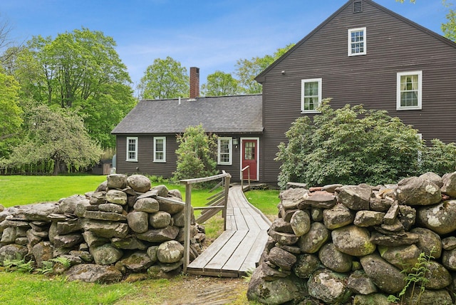 19 Bearce Rd, Winthrop, ME 04364 - view of front of house with a chimney, a front lawn, a shingled roof, and a wooden deck