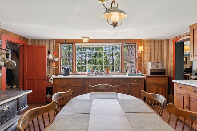 19 Bearce Rd, Winthrop, ME 04364 - kitchen featuring wallpapered walls, a sink, brown cabinets, and light countertops
