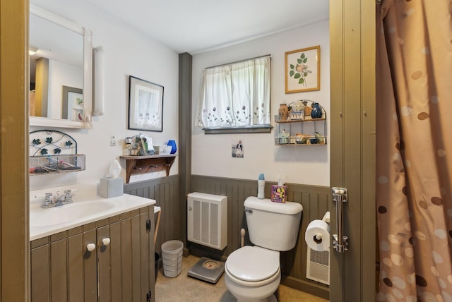 19 Bearce Rd, Winthrop, ME 04364 - bathroom featuring toilet, wainscoting, heating unit, and vanity