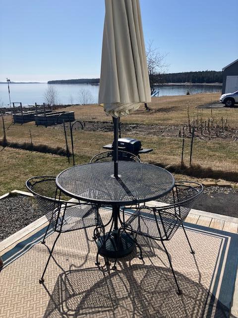 66 Robins St, Robbinston, ME 04671 - view of patio / terrace with a water view