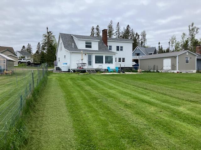 66 Robins St, Robbinston, ME 04671 - rear view of house with a chimney