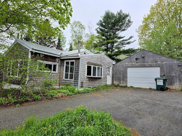 1330 Pushaw Rd, Glenburn, ME 04401 - view of property exterior with a garage, driveway, and metal roof