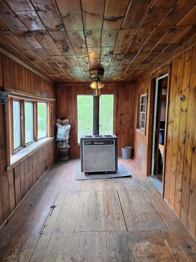 1330 Pushaw Rd, Glenburn, ME 04401 - living room with a wood stove, wood-type flooring, healthy amount of natural light, wooden ceiling, and wooden walls