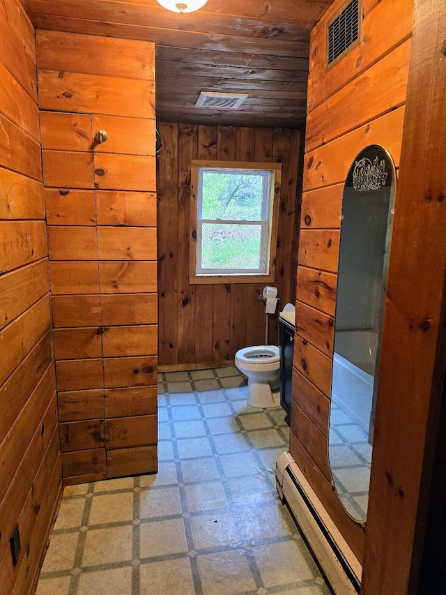 1330 Pushaw Rd, Glenburn, ME 04401 - full bath with tile patterned floors, baseboard heating, wooden ceiling, wooden walls, and toilet