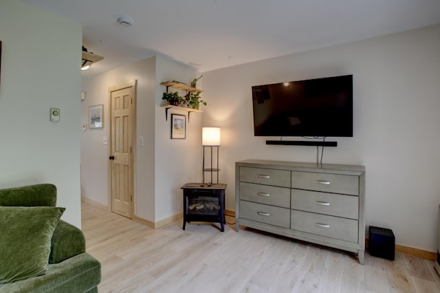5 Glenridge Dr Unit 5, Portland, ME 04102 - living room with light wood-style flooring, baseboards, and a wood stove