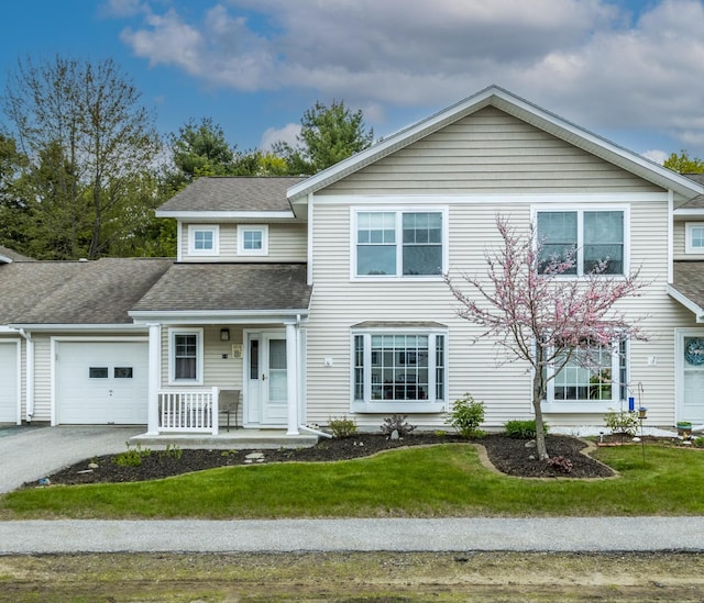 14 Chickadee Cir Unit 14, Brunswick, ME 04011 - view of front of property with a porch, a garage, a front yard, driveway, and roof with shingles