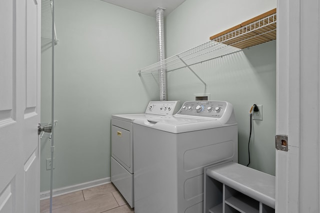 14 Chickadee Cir Unit 14, Brunswick, ME 04011 - washroom featuring washer and clothes dryer, baseboards, and light tile patterned flooring