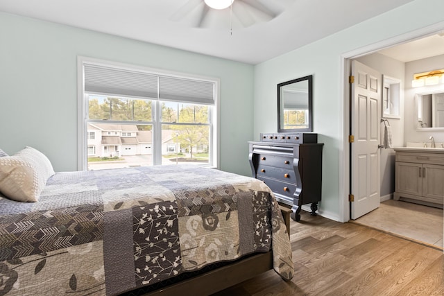 14 Chickadee Cir Unit 14, Brunswick, ME 04011 - bedroom with light wood-style floors, a sink, ensuite bathroom, and ceiling fan
