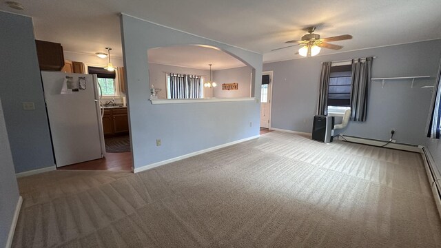 60 Twig Cir, Harrison, ME 04040 - spare room featuring light colored carpet, ceiling fan, arched walkways, baseboards, and a sink