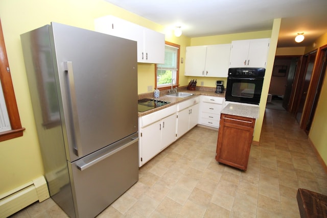 kitchen with black appliances, a baseboard radiator, a sink, and white cabinetry