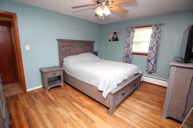 bedroom featuring baseboard heating, light wood-type flooring, a ceiling fan, and baseboards