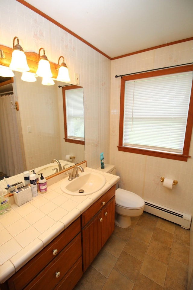 full bathroom featuring a baseboard heating unit, ornamental molding, toilet, vanity, and tile patterned flooring