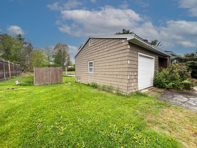 view of property exterior featuring a garage and asphalt driveway
