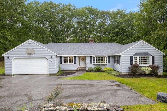 18 Ginger Ln, Saco, ME 04072 - ranch-style home featuring asphalt driveway, a garage, a chimney, a shingled roof, and a front lawn