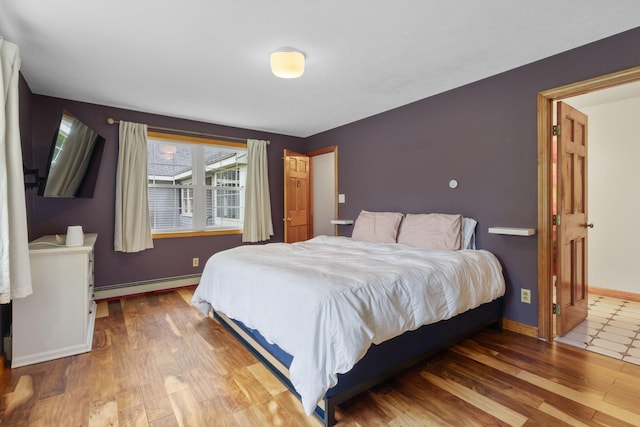18 Ginger Ln, Saco, ME 04072 - bedroom featuring a baseboard heating unit, wood finished floors, and baseboards
